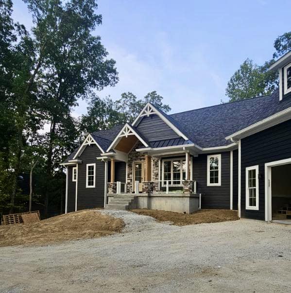 Front view of a house with dark blue exterior paint by Reardon Painting.